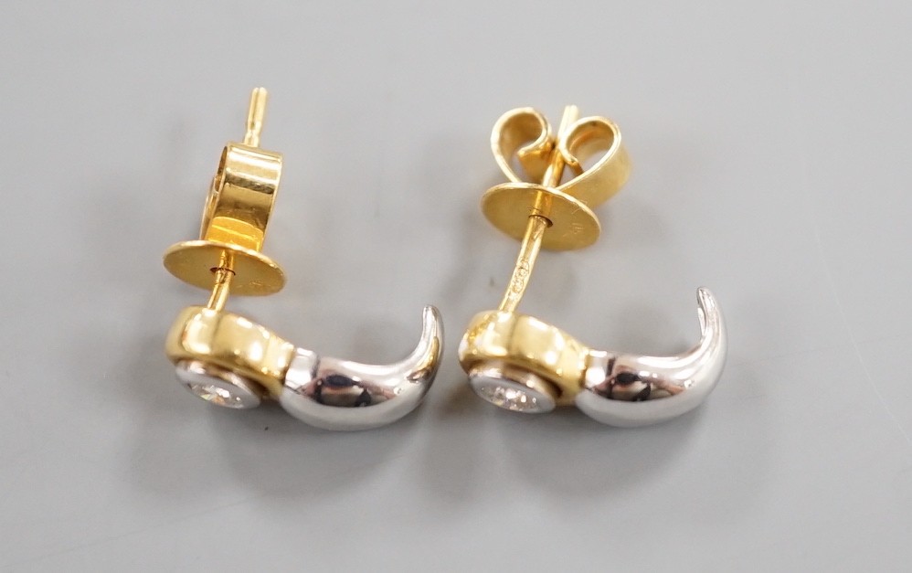 A modern pair of two colour 750 metal and single stone diamond set earrings, 12mm, gross weight 2.9 grams.